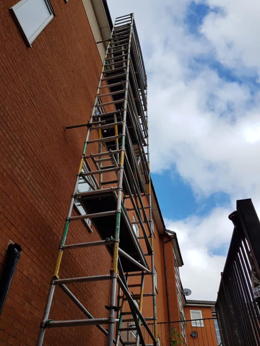 Tall access tower on a red-brick property