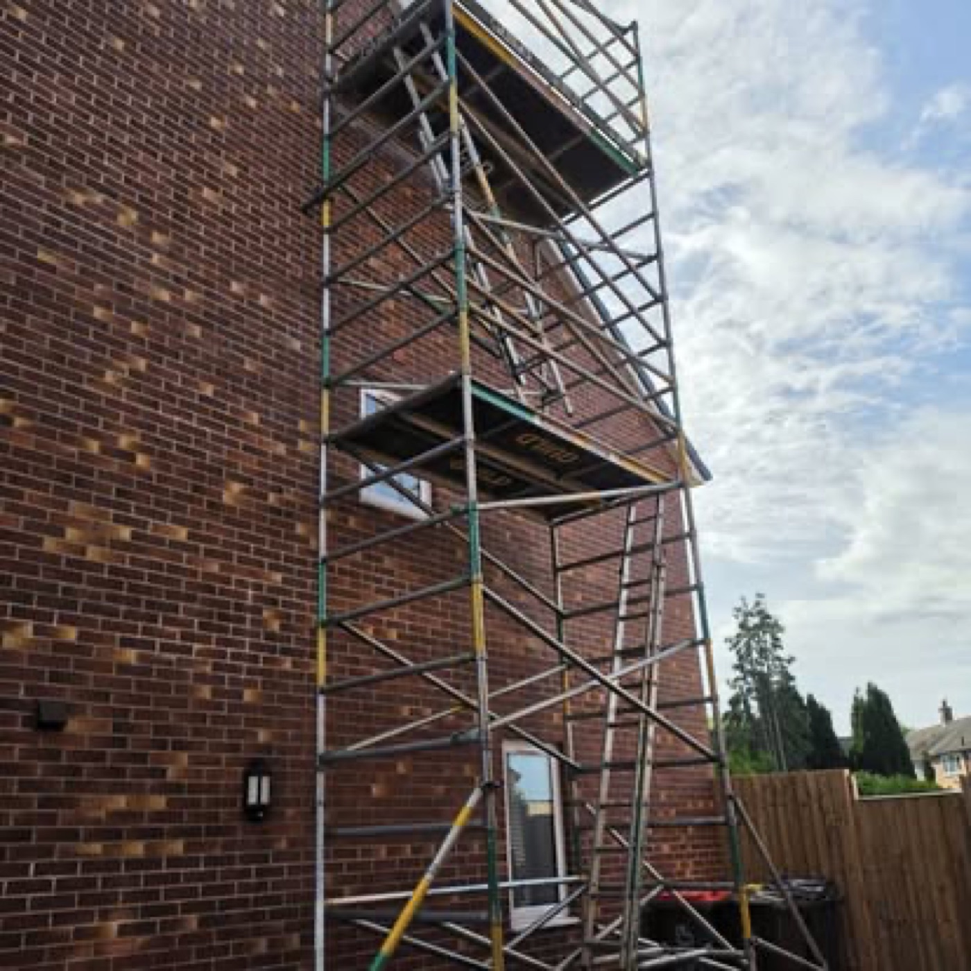 Multi-storey access tower on red brick